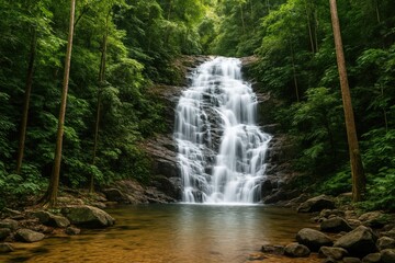 Obraz premium Breathtaking waterfall surrounded by tropical rainforest in a mountain region