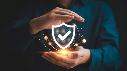 Person s hands protectively cradling a glowing digital shield with a checkmark symbolizing security and safety