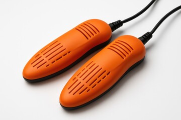Electric shoe heater in vibrant orange color isolated on white background