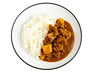 A delicious plate of rich meat and potato curry served with fluffy white rice top view.