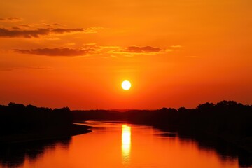 Fototapeta premium Vivid orange sunset illuminates a celestial river across the sky