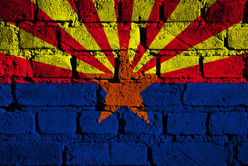 Creative mural depicting the vibrant Arizona flag on a brick wall