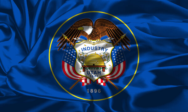 Utah state flag waves gracefully under a bright blue sky