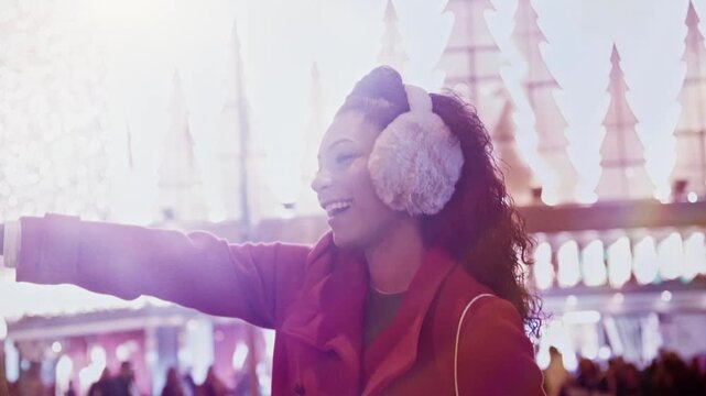 Young woman hailing a cab after christmas shopping, wearing earmuffs and a red coat