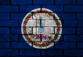 Virginia state seal painted on a textured blue brick wall