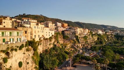 Obraz premium Scenic aerial panorama of Tropea cityscape and coastline with cliffs and clear waters