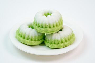 "Kue Putu Ayu"  steamed rice cakes found in Southeast Asian culinary traditions, often flavored with pandan and topped with grated coconut.