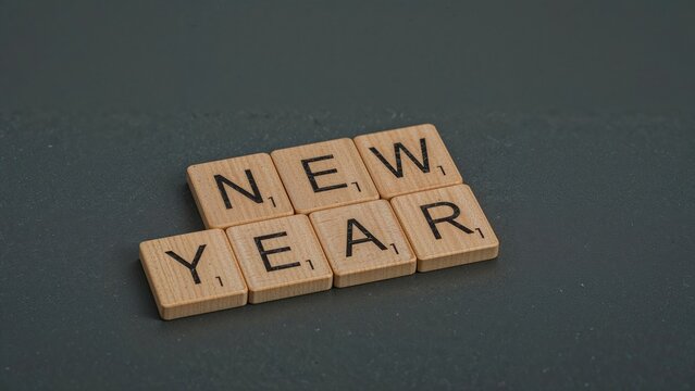 Moving from the old year to the new using wooden block cubes. - Powered by Adobe