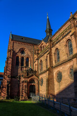 Fototapeta premium courtyard with meadow in front of a medieval sand-colored church