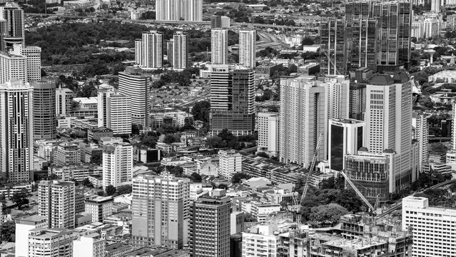 Kuala Lumpur, Malaysia - December 28, 2019: Dramatic aerial view of Kuala Lumpur skyline on a cloudy day with misty skyscrapers