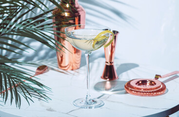 Turf Club alcoholic cocktail drink with gin, vermouth, liqueur, absinthe, bitters and lemon twist with copper bar tools