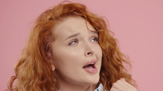 Bored red-haired woman pretending to yawn and roll eyes during awkward situation