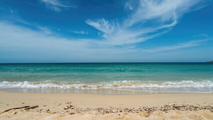 Nature scene with sea, waves, and sandy shore under clear sky