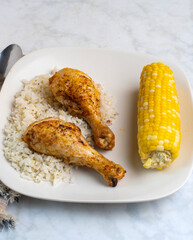 chicken drumsticks with rice and  corn