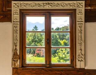 Rustic charm: Vintage window with carved frame revealing lush garden view