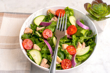 chicken salad with tomatoes , lettuce  and  cucumbers