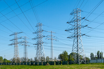 High voltage electricity pylons and power lines in open landscape