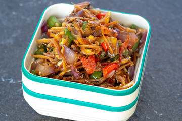 A close-up shows 'Sambal Teri Kacang', a spicy and savory Indonesian dish made of fried anchovies, peanuts, chilies, and onions, served in a plastic container.