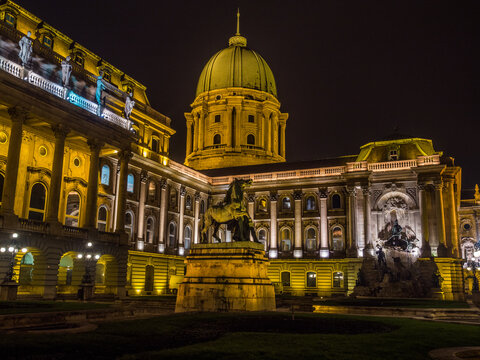 Budapest, Hungary – Night view of Buda Castle with illuminated dome and equestrian statue at the Royal Palace. - Powered by Adobe