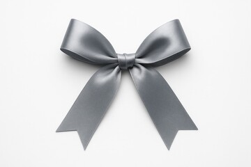 Naklejka premium Gray ribbon fashioned into a bow set on a plain white surface