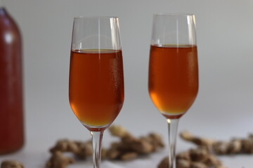 Ginger wine in clasp bottle and flutes with fresh root showing Indian wellness and artisanal heritage