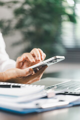 Finance bank tax expense accounting budget money businessman hand use calculator Financial calculate accountant close up calculator with graph chart write office desk Business expense analysis saving