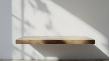 Wooden shelf against a light wall with shadows