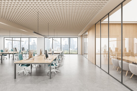 Modern open space office interior with workstations, glass meeting room and city view through large windows in bright daylight. 3D Rendering