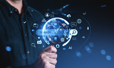 Man holding magnifying glass with digital globe and search icons representing internet and information technology concept on futuristic background.