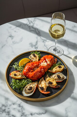Luxury Seafood Platter with Lobster, Oysters and Caviar Served with White Wine on Marble Table