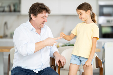 Fototapeta premium Father and daughter playing rock paper scissors