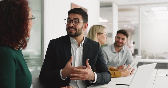 Young Arabian professional man in suit shaking hands with woman client during formal meeting in office, concluding agreement, sell company services, make deal, feel satisfied with negotiation outcome