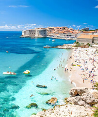 Crowded Beach by Historic City Walls