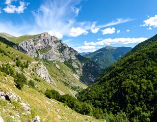Fototapeta premium Majestic Mountain Range with Lush Green Valleys and a Dramatic Sky Landscape