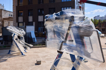 Heavy construction equipment wrapped securely for protection during transportation and storage