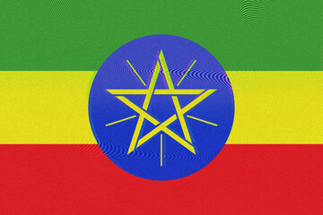 A vibrant artistic rendering of the Ethiopian flag features green, yellow, and red horizontal bands. An intricate golden star rests on a blue circle, displayed with textured and