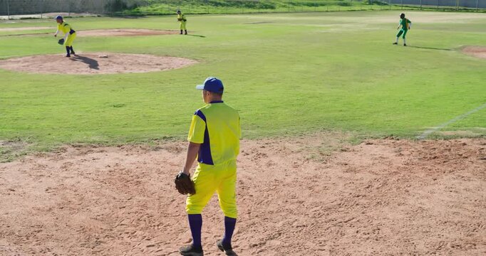 Reacting to batter hitting pitch, male third baseman moving glove to tag runner near third base