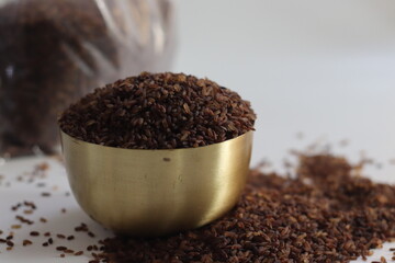 Niranam black rice in brass bowl with brown grains, symbolizing Kerala culinary heritage and pride
