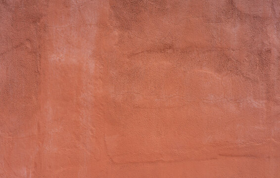 Stucco wall, terracotta plaster rough wall texture background