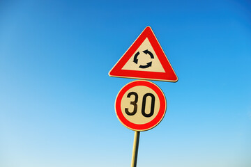 Traffic roundabout and speed limit sign