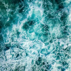 Fototapeta premium Oceanic Embrace: An abstract aerial shot of the sea presents a stunning display of churning turquoise waters.
