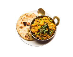 Aloo Matar Sabzi a spicy Indian potato and pea curry served in a brass kadai with fresh roti.
