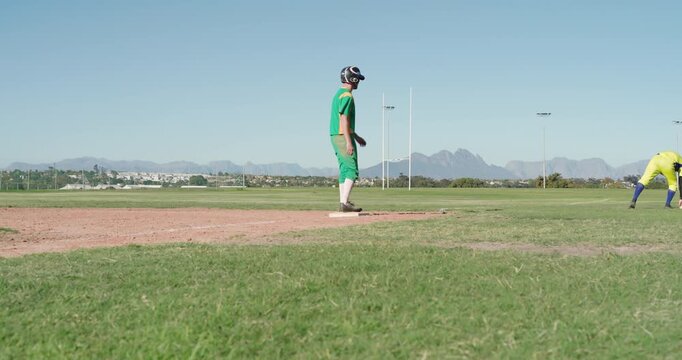 Spotting runner on first base, fielder adjusting glove while runner crouching leadoff on field
