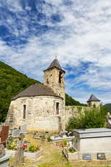 Fototapeta premium Medieval Church and Cemetery Overlooking Picturesque Valley in Ustou, France