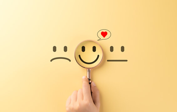Mental Health Care and Positive Wellbeing Concept. A magnifying glass focuses on a happy, smiling face, symbolizing mental health care, positivity, and emotional well-being. customer satisfaction,