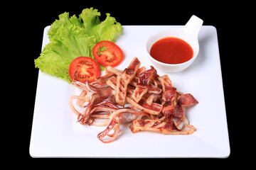 Deep-fried Sun-Dried Squid on a white plate Garnish with lettuce and tomato