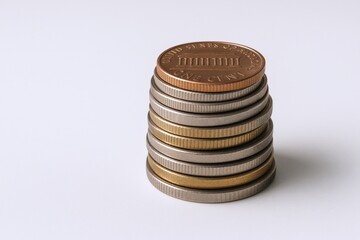 Stack of mixed value United States coins showcasing financial savings and investment on white background