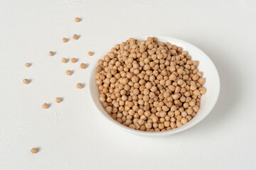 Raw chickpeas. In a white bowl. On a white background. Ready to prepare any delicious recipe.