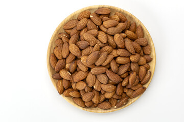 Roasted almond, wooden plate, top view, healthy snack, brown nut, scattered, white background