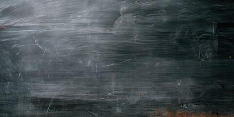 Obraz premium textured black surface with scratches, resembling a chalkboard or slate, showcasing a rustic and vintage aesthetic.